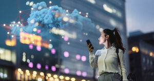 Woman uses her smartphone outside in a city's business district at dusk.
