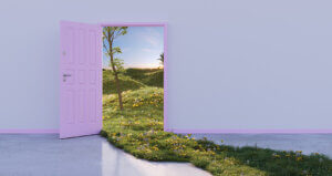 A door on a blank wall opens to a field in nature