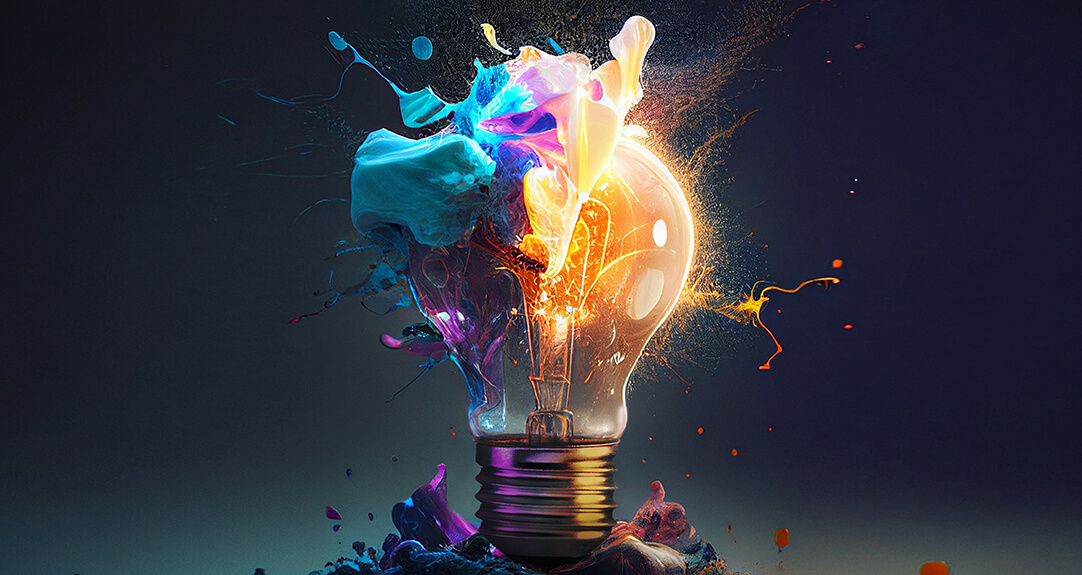 An abstract representation of actuarial innovation featuring a lightbulb bursting with vibrant splashes of color against a dark background.