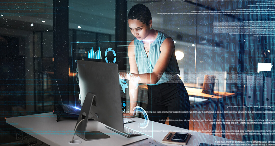 A professional stands at an office desk, engaging with a computer screen. An overlay of digital charts and code suggests the use of GenAI to analyze complex information.