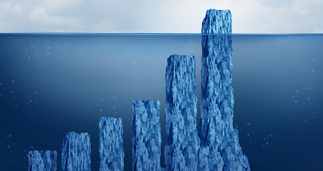 A series of iceberg-like structures rising from below the water's surface. Each structure varies in height, resembling the bars of a graph, with the tallest iceberg on the right and the shortest on the left.