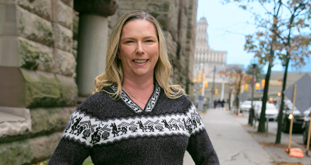 Actuary Karen Burnett smiles as she stands outside in downtown Toronto on a chilly day.