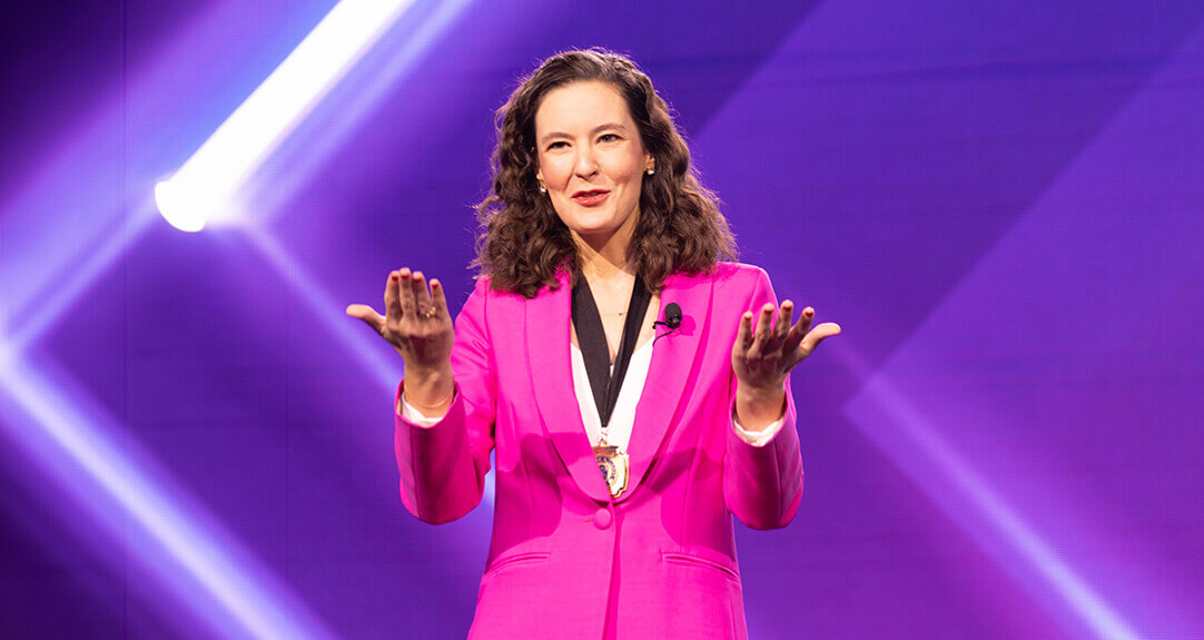 Amanda Hug, wearing a pink power suit, speaks during her inauguration ceremony.